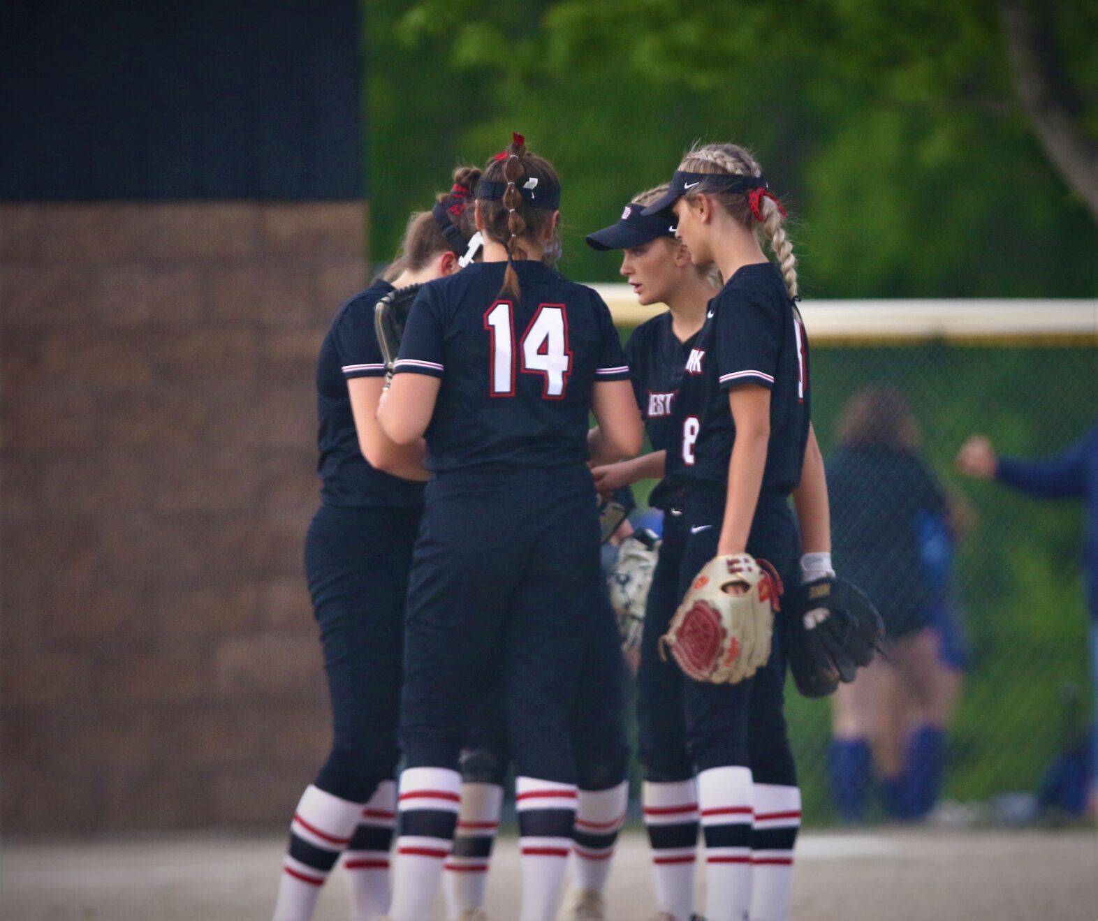 West Fork players talking in circle at Central Springs 6/1/22